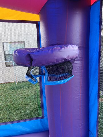 bounce house with slide and basketball hoop