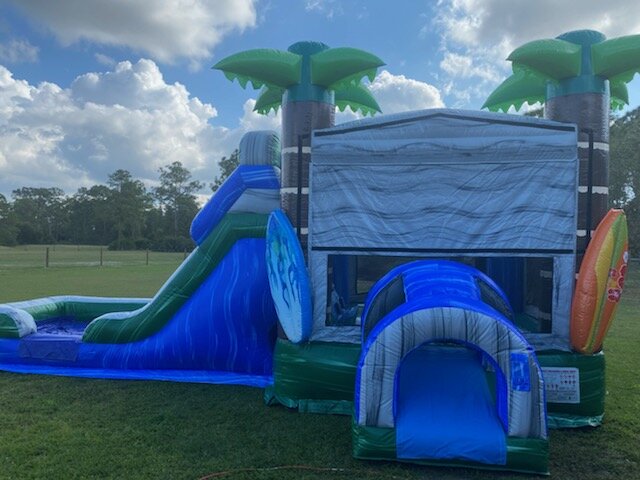 Surfer themed bounce house with a slide