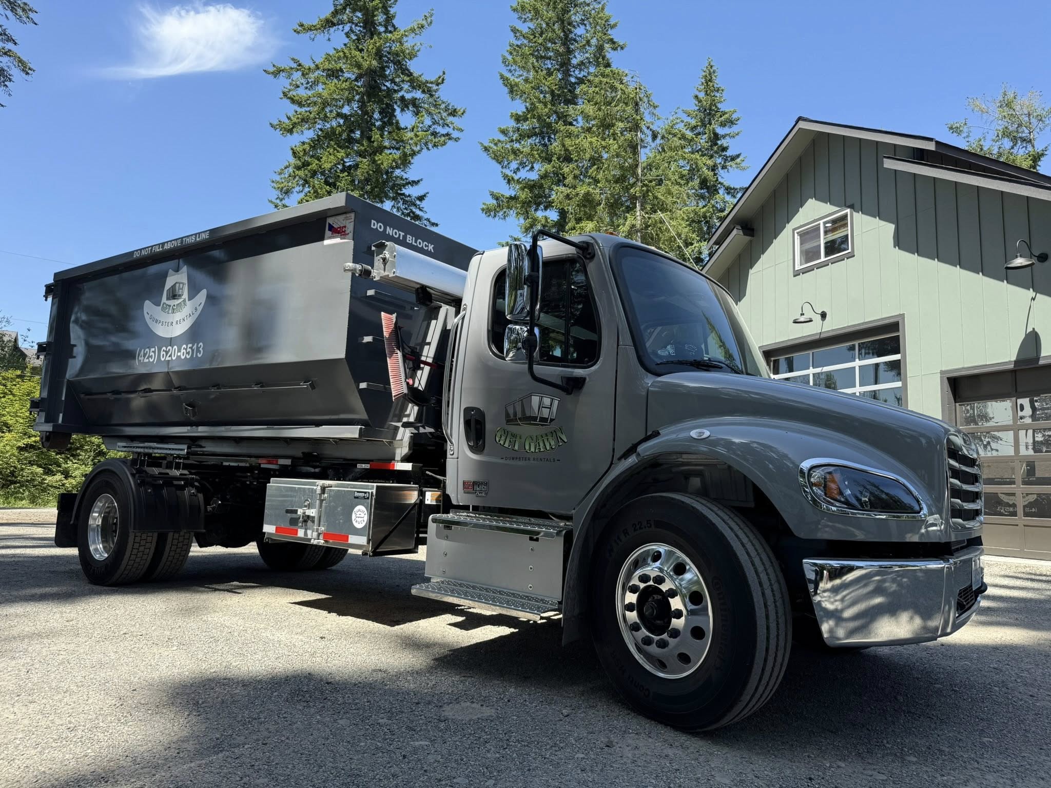 Get Gawn Dumpster Rental gray truck parked near a residential property on a sunny day