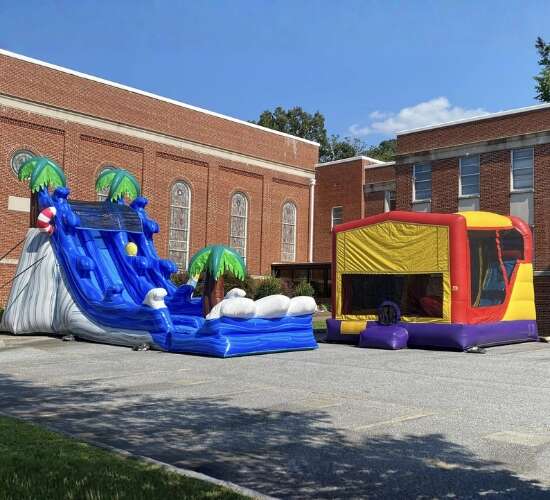 GoodTymes Inflatables inflatable setup in front of building with bounce house and water slide
