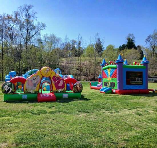 GoodTymes Inflatables obstacle course and bounce house setup on grassy field