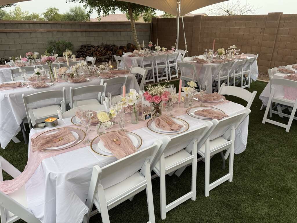 Backyard party table and chair rental setup with 6 foot tables and white resin chairs in Goodyear Arizona