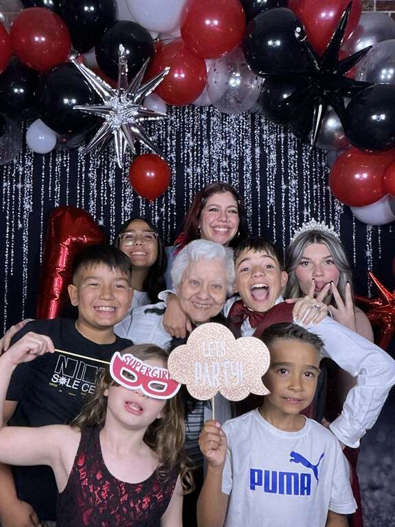 Birthday party photo booth rental with guests themed props and custom backdrop in Goodyear Arizona