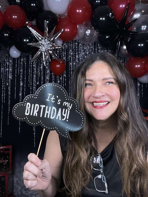 Birthday party photo booth rental with guests themed props and custom backdrop in Goodyear Arizona