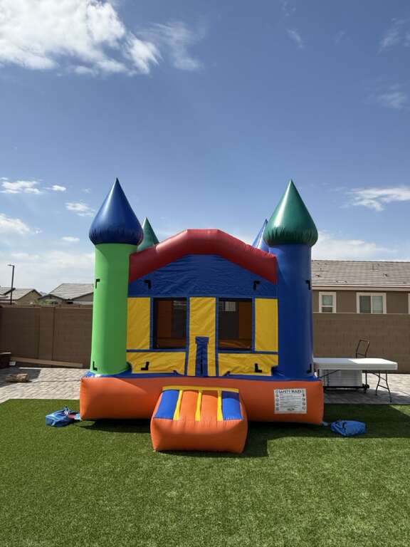 13x13 bounce house rental professionally set up in a Waddell backyard