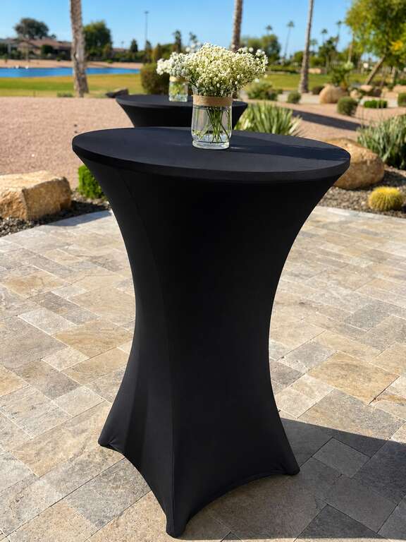 Cocktail table rentals with black spandex covers for a wedding reception in Goodyear Arizona