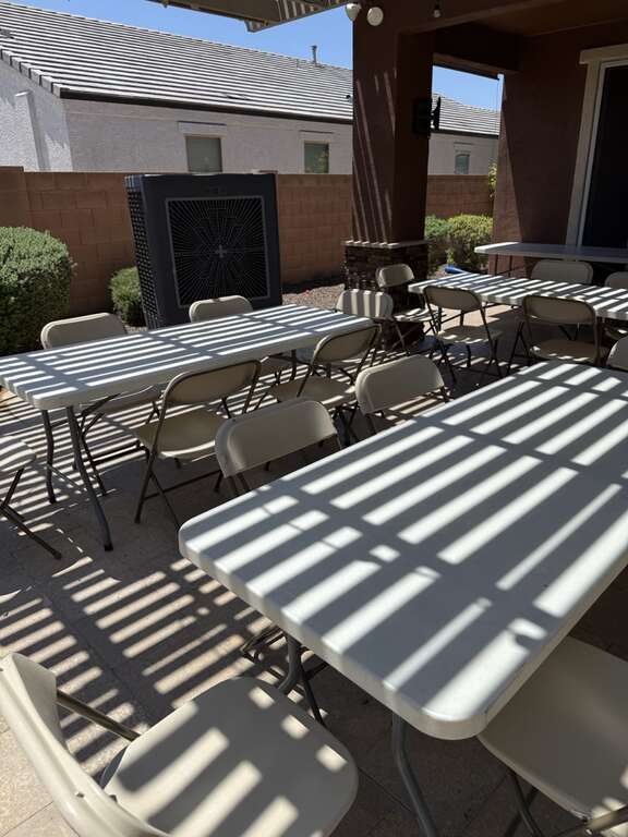 Commercial swamp cooler with backyard party tables and chairs in Goodyear Arizona