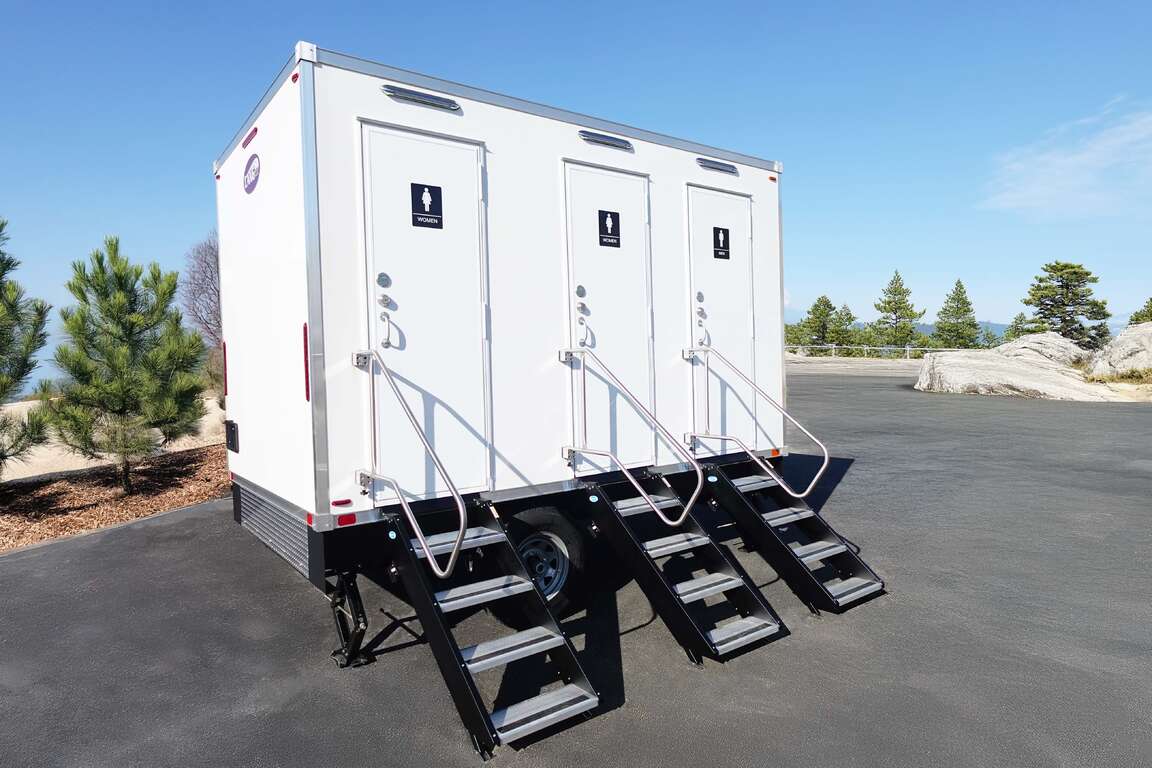 Wide exterior view of the full 3-stall bathroom trailer