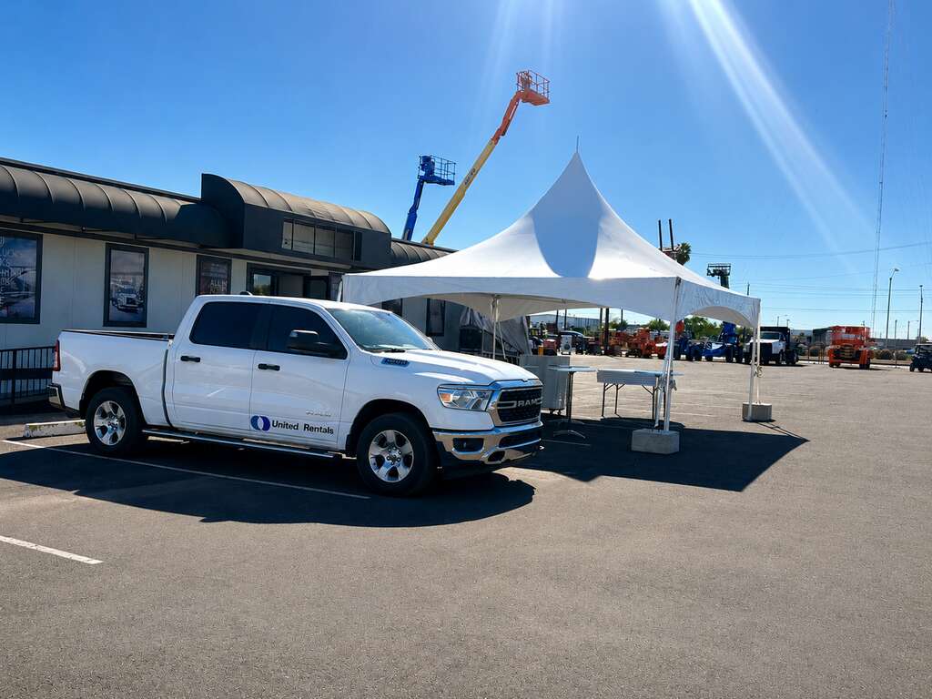 20 by 20 high peak tent with concrete ballast, cocktail tables, round tables and chairs installed for a United Rentals corporate event in Phoenix, Arizona
