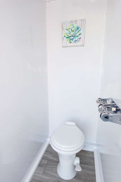 Private flushing toilet compartment inside luxury restroom trailer in Phoenix Arizona