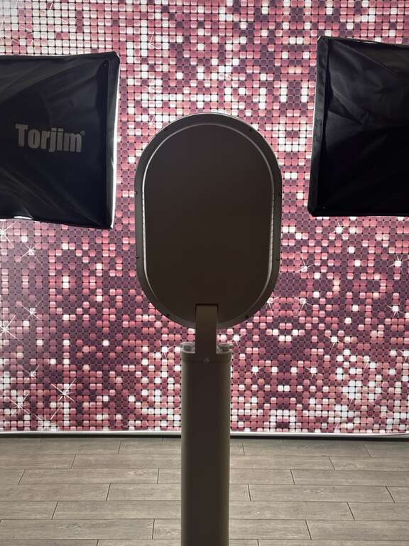 Digital photo booth rental with sequin backdrop and professional lighting for an event