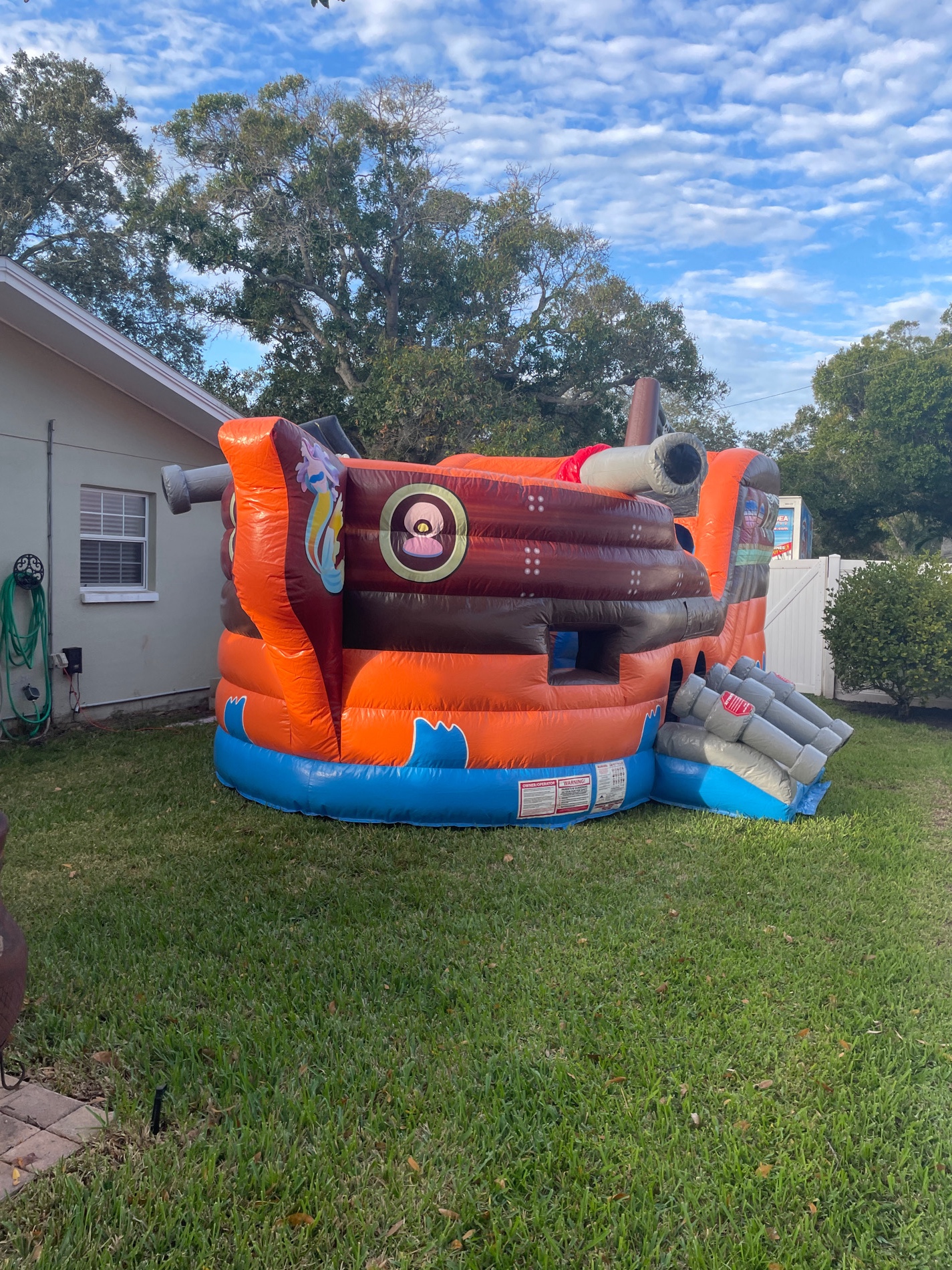 Colorful pirate bounce house setup in Tampa backyard event