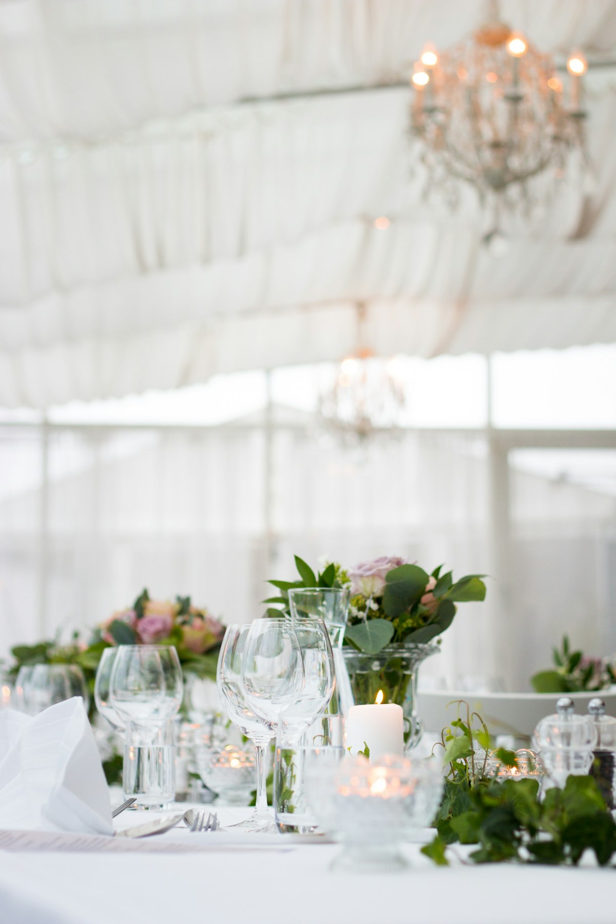 draped tent ceiling with chandeliers at an elegant reception