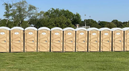 Portable restroom rentals at an outdoor event by Grand Restrooms