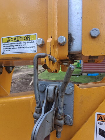 Upper boom retention clamp