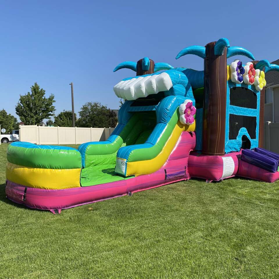 Colorful bounce house combo with a slide from Hang Time Rentals, professionally cleaned and ready for birthday parties, school events, and family celebrations.