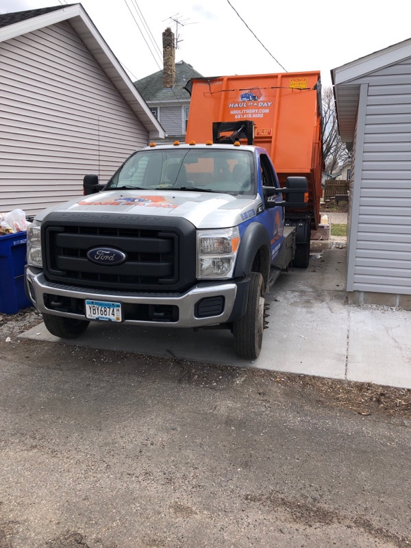 Photo of 20 yard dumpster being placed in alley driveway