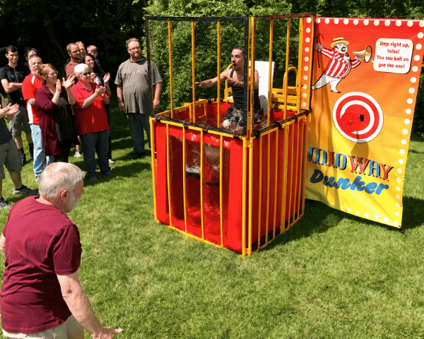 Dunk tank set up with a crowd cheering