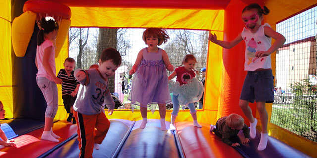 Children having fun in a colorful bounce house from Hop A Lot Moonwalks Children having fun in a colorful bounce house from Hop A Lot Moonwalks