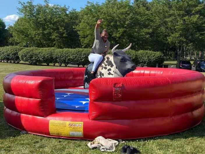 Person riding a mechanical bull at a Hop A Lot event Person riding a mechanical bull at a Hop A Lot event