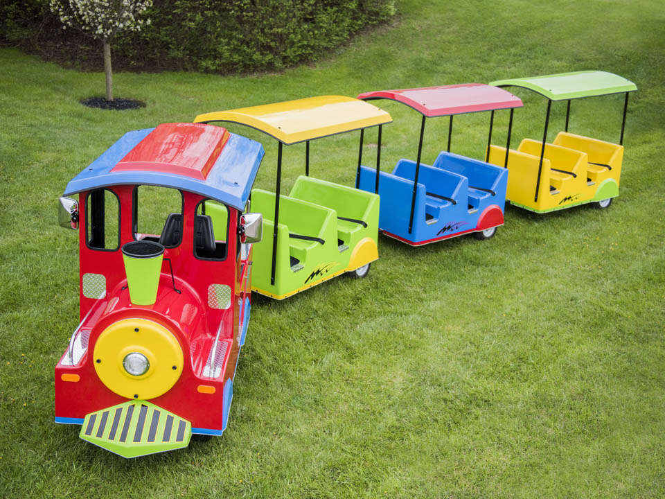 Children riding a colorful trackless train at a Hop A Lot event Children riding a colorful trackless train at a Hop A Lot event