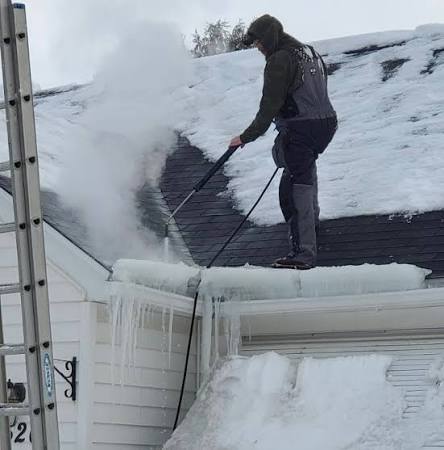 Massive ice formation covering the edge of a residential roof
