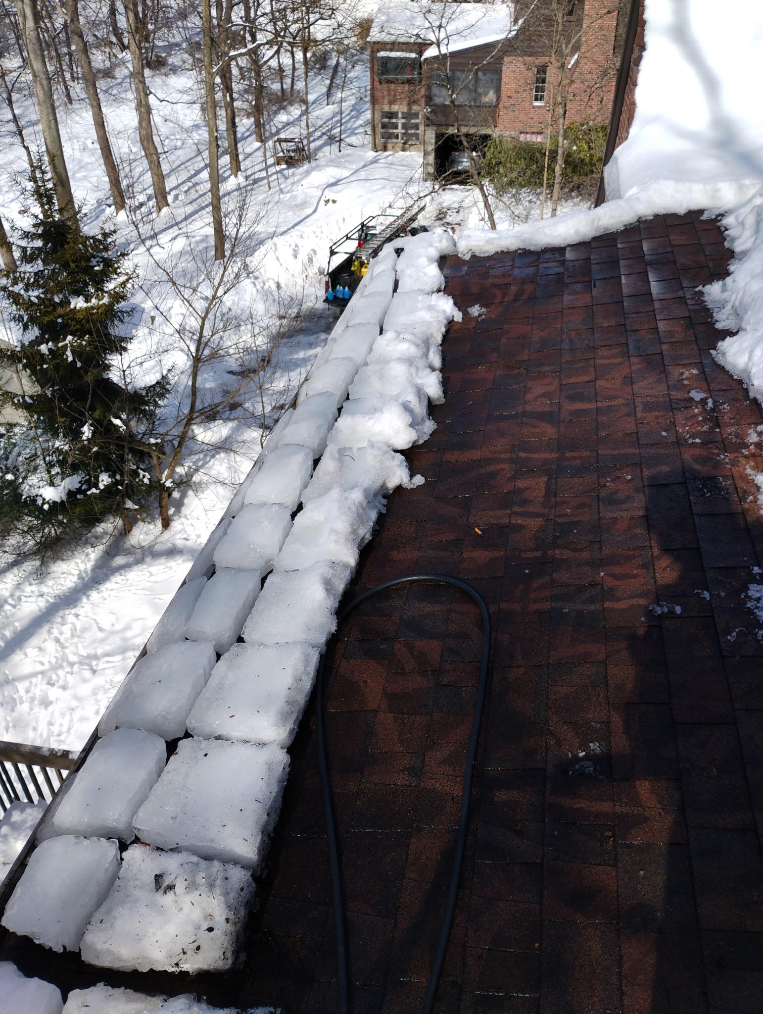 Heavy ice buildup covering gutters and roof edges during winter