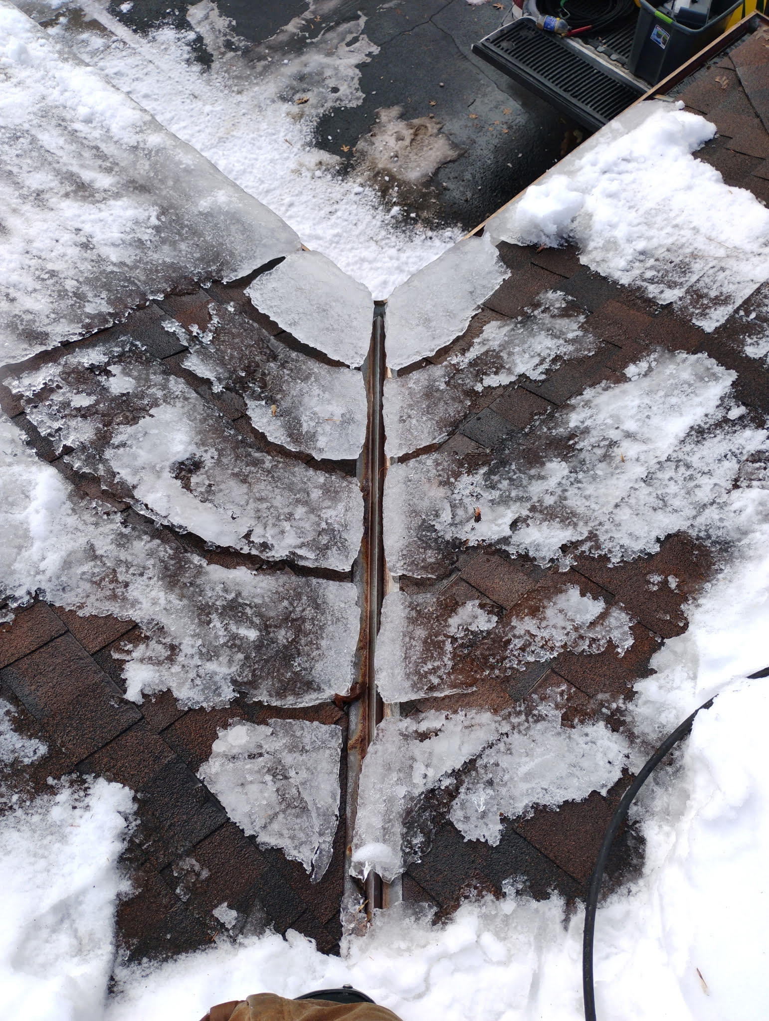 Severe gutter ice buildup along the roofline of a Minnesota home