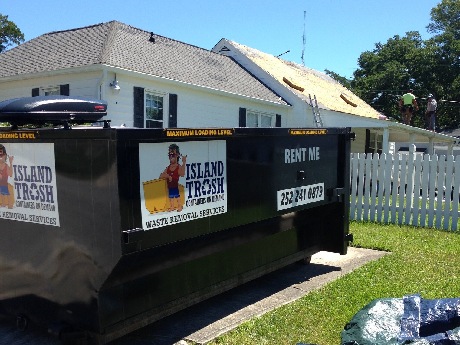 Roll-off dumpster at a residential property Roll-off dumpster at a residential property