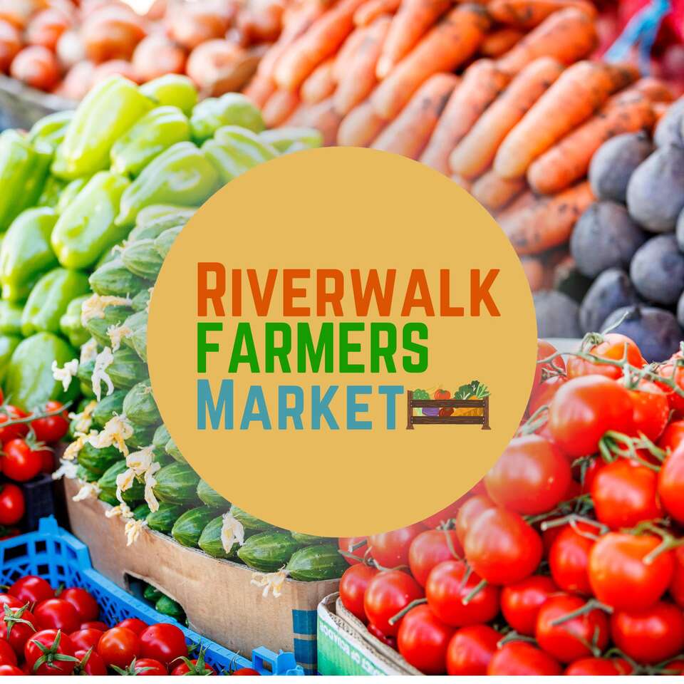 Riverwalk Farmers Market logo over fresh produce display including tomatoes, carrots, and peppers.