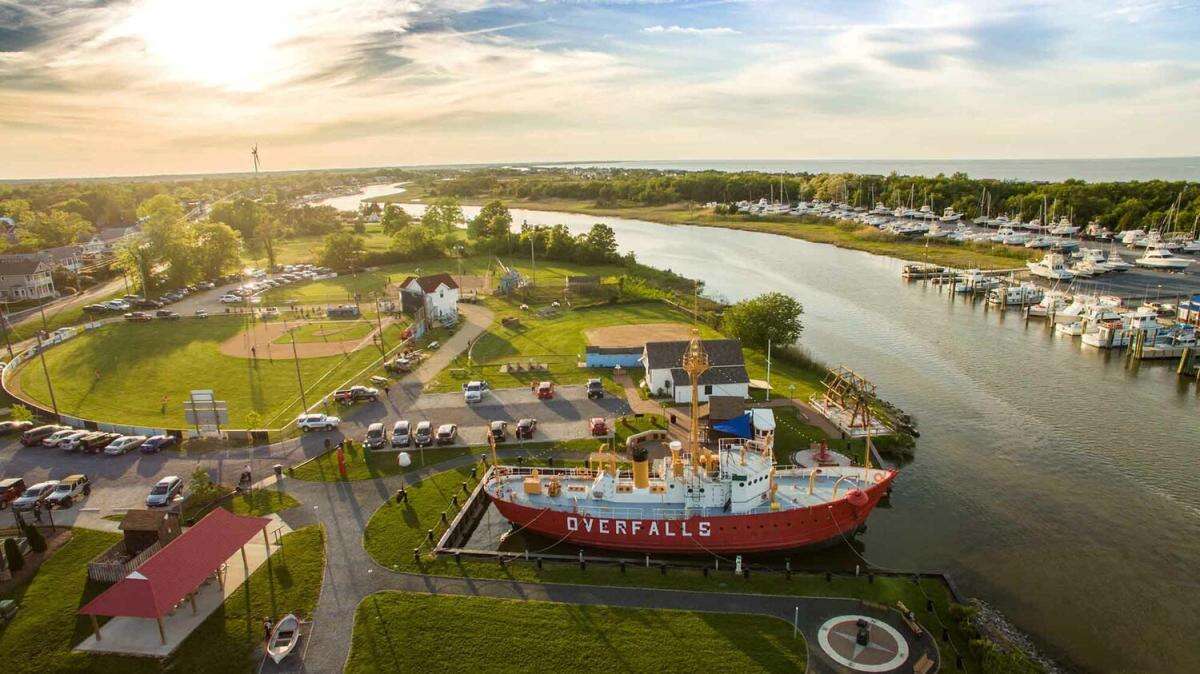 Aerial view of the Lightship Overfalls museum and marina in Lewes, Delaware at sunset.