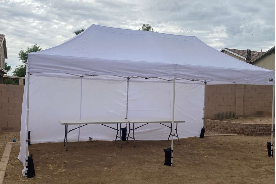 10x20 white canopy tent set up in a backyard in Avondale, AZ