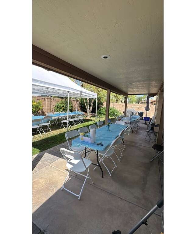 Backyard party setup with tables, chairs and canopy in Glendale, AZ by Johnny's Party Co