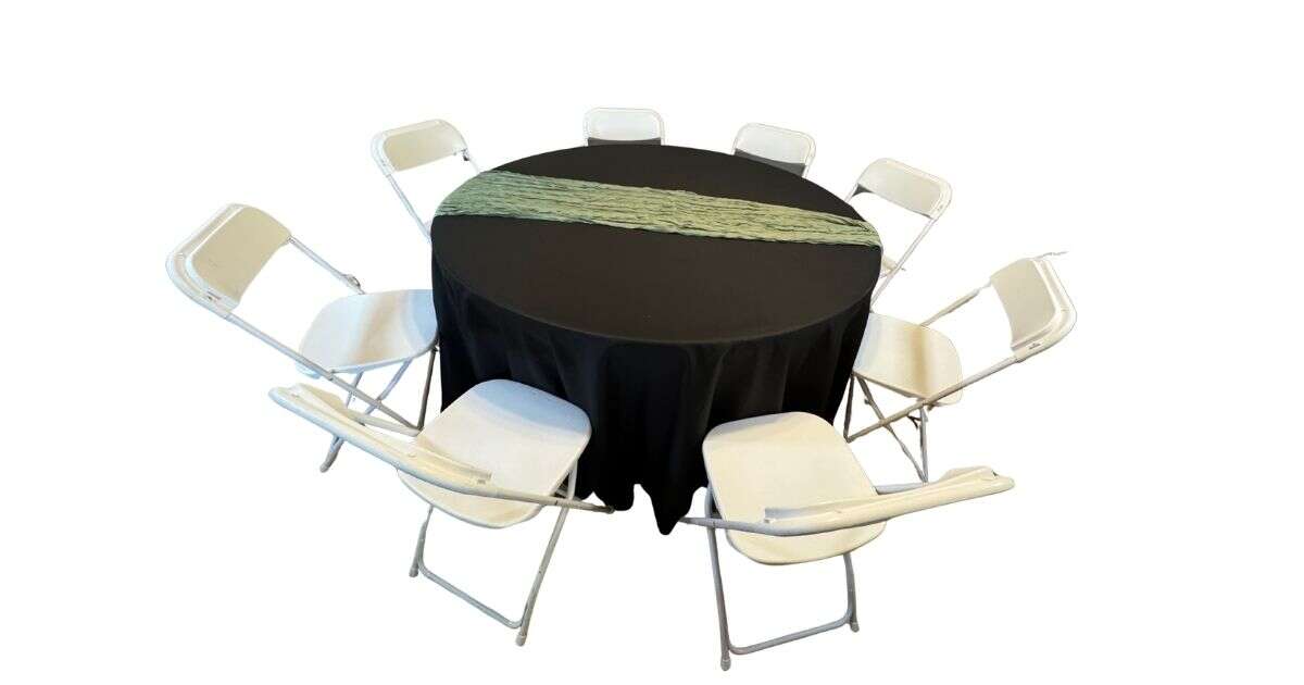 Round table with white resin chairs and black linens set up for an elegant event in Goodyear, Arizona