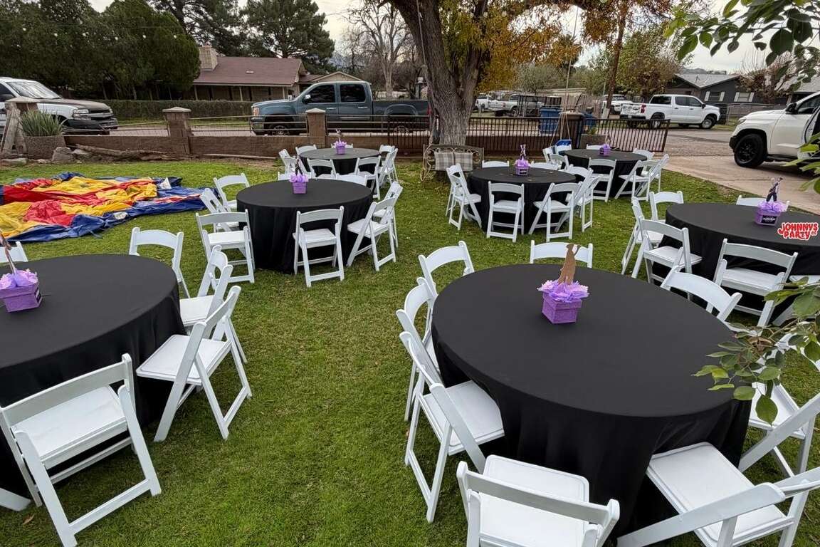 White resin chairs with round tables and black tablecloths, Phoenix AZ