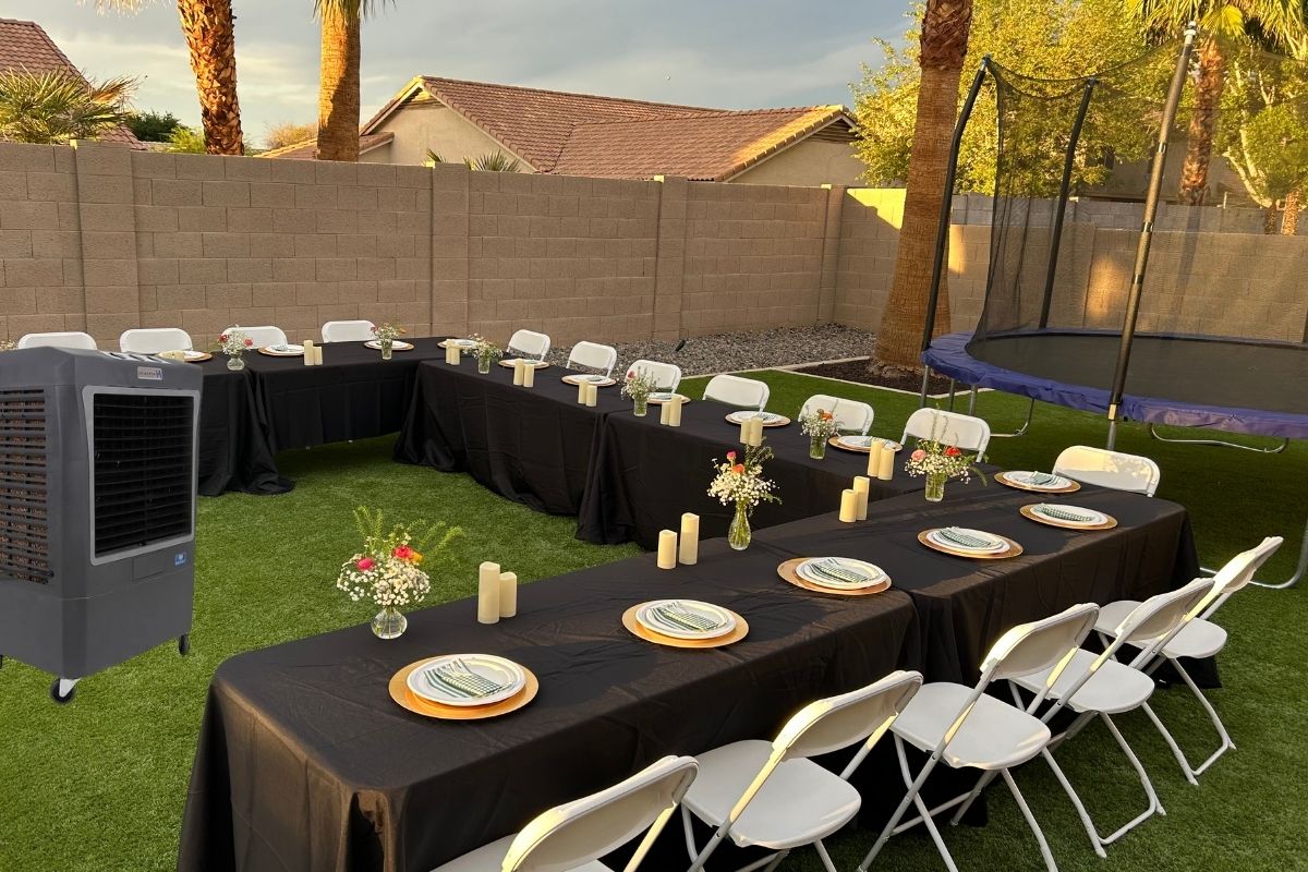 Backyard event setup in Glendale AZ with banquet tables, white folding chairs, black linens, and portable swamp cooler rental for outdoor guest comfort. Backyard event setup in Glendale AZ with banquet tables, white folding chairs, black linens, and portable swamp cooler rental for outdoor guest comfort.