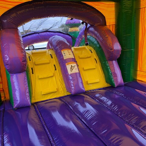 Jungle-themed dual water slide bounce house set up in Louisburg, NC