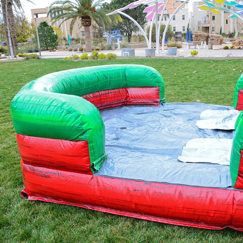 Midnight-colored combo bounce house setup with water slides in Garner, NC