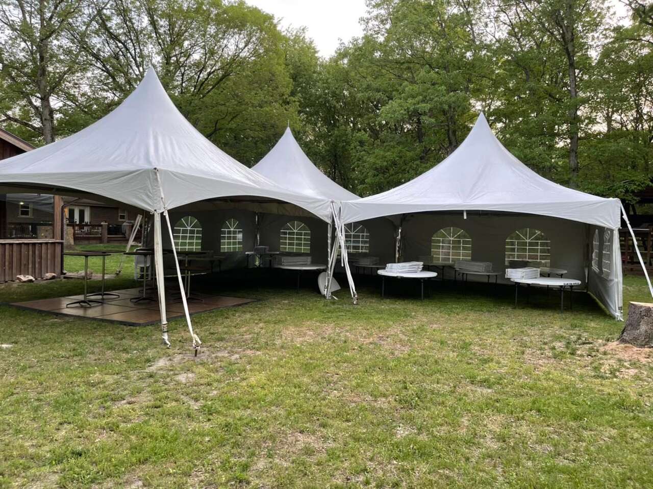 Tuskany Events **multiple high-peak tents** set up for a party with tables and dance floor.