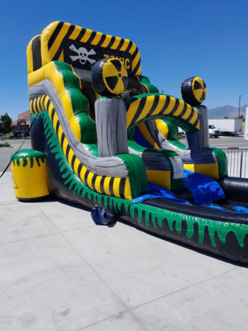 A large inflatable water slide featuring a skull and crossbones design, perfect for adventurous summer fun.