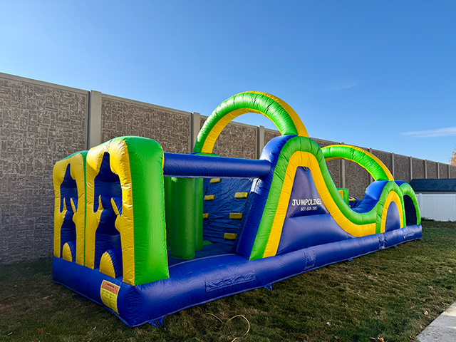 Kids racing through the 35ft Radical Run obstacle course rental in Utah