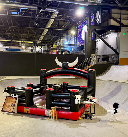 Mechanical bull in a skate park inside the bowl for an event