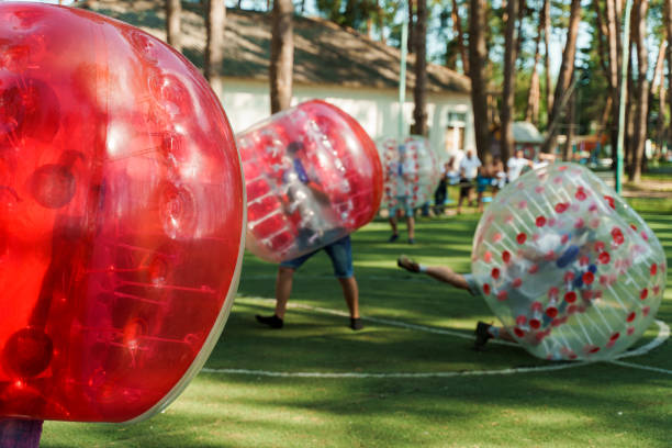 Kids playing inside of inflated bumper balls during a field day