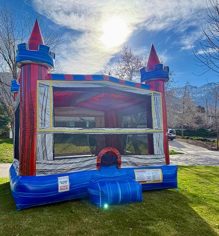Large castle tower bounce house setup outdoors for Utah backyard birthday party and event rental