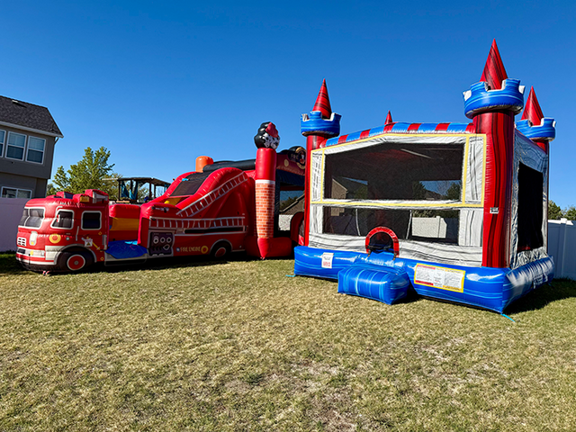 Fire truck inflatable and a castle bounce house set up for a Childs birthday