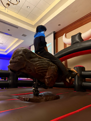 Young kid riding mechanical bull at a party