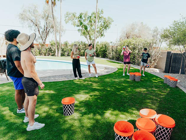Two teams competing in BasketPong outdoor basketball pong game at a Utah party