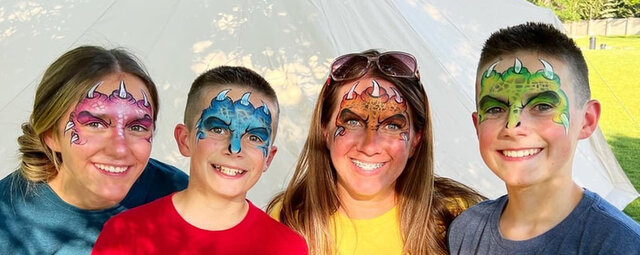 Four friends with matching face painting with claws done by a professional artist. 