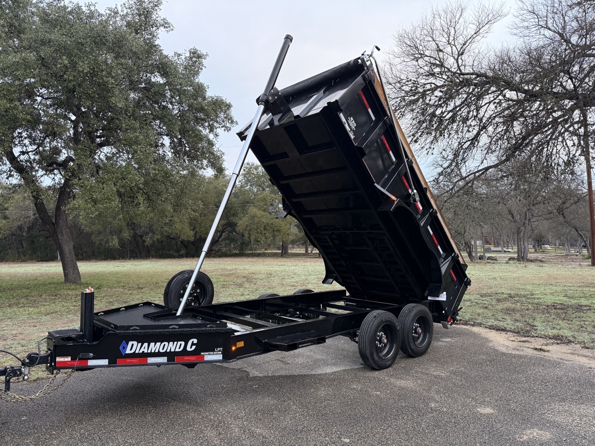 Diamond C dump trailer in action - hydraulic lift dumping debris