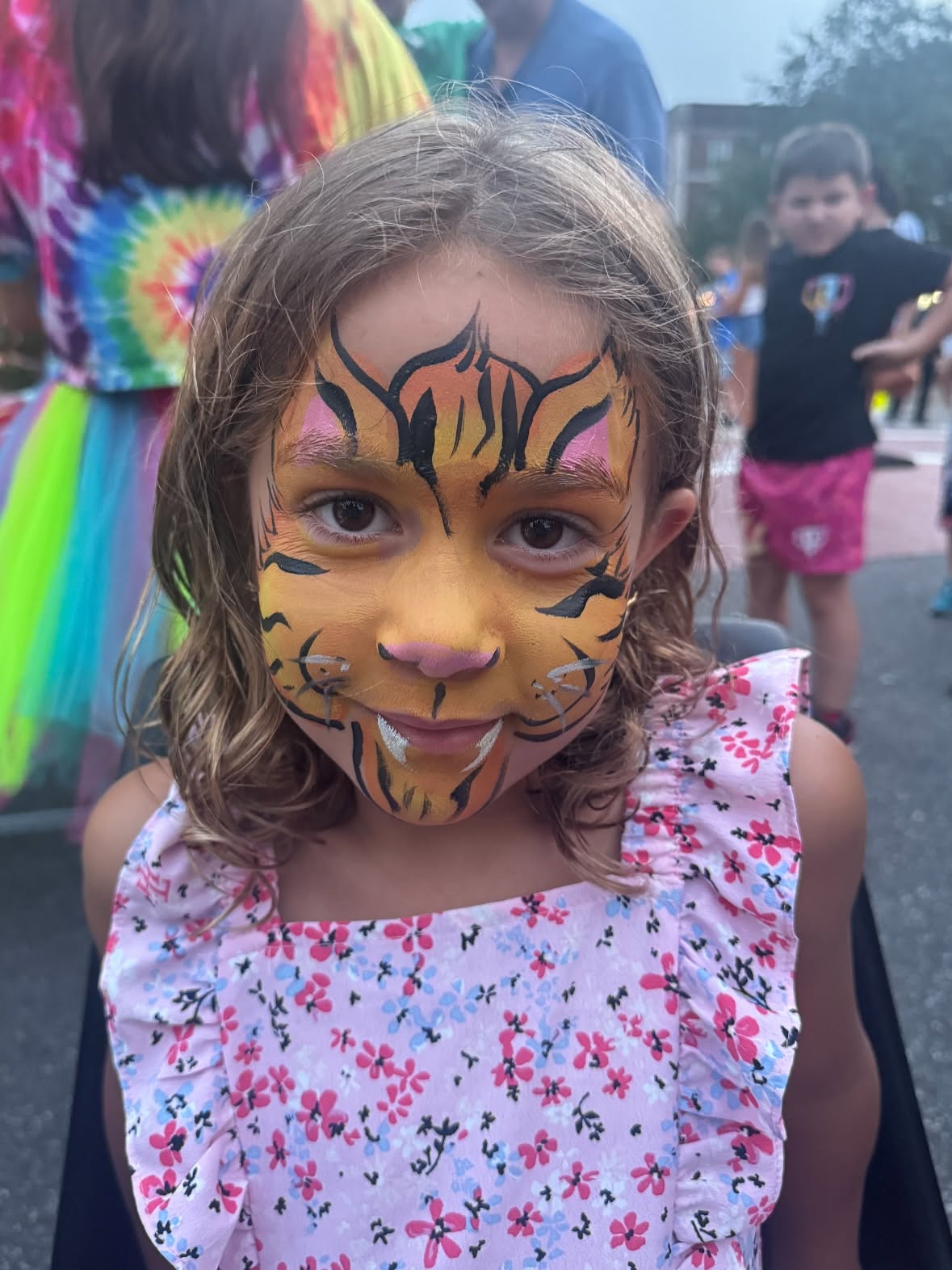 Face painter entertaining kids at a Long Island party